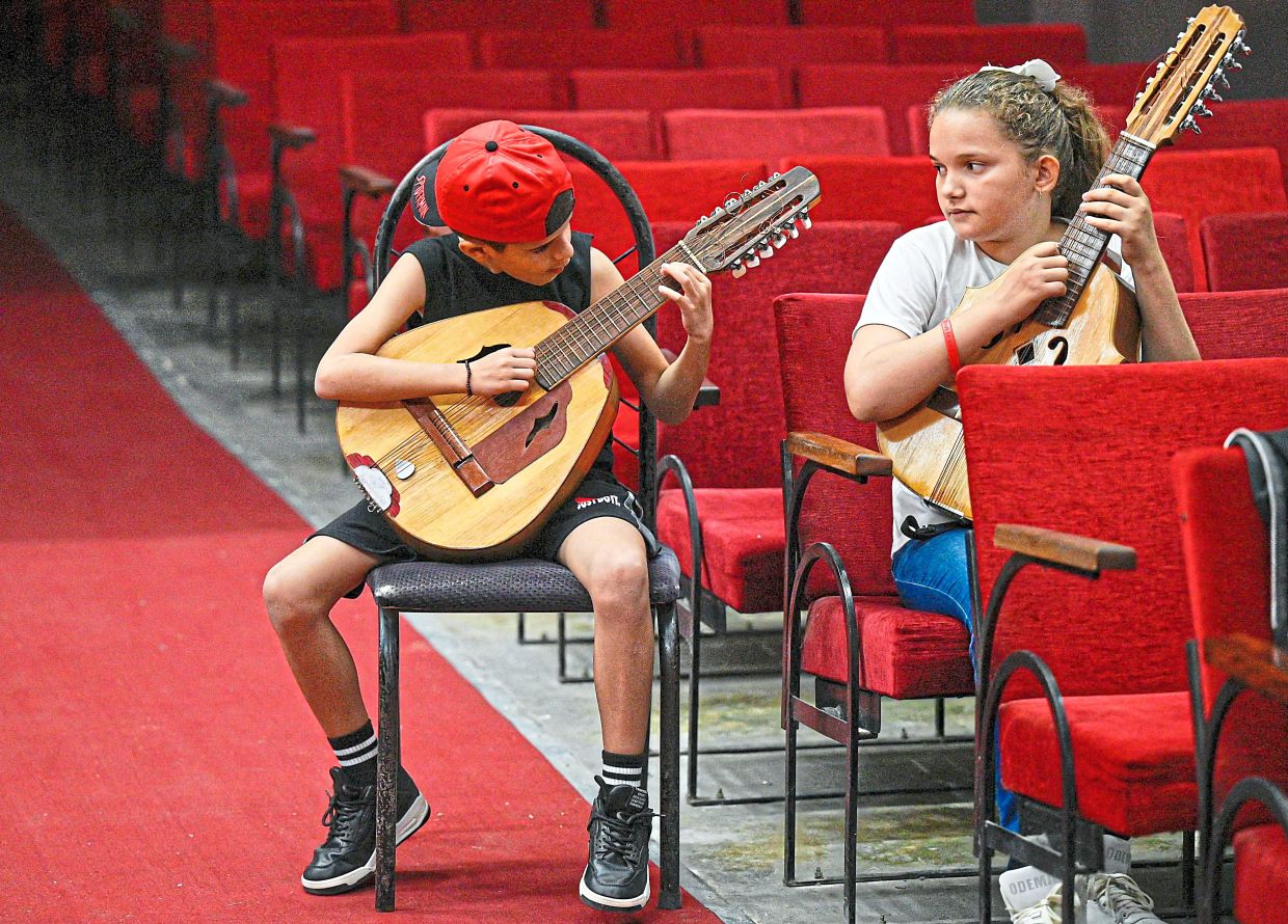 Members of the group perform during a rehearsal.