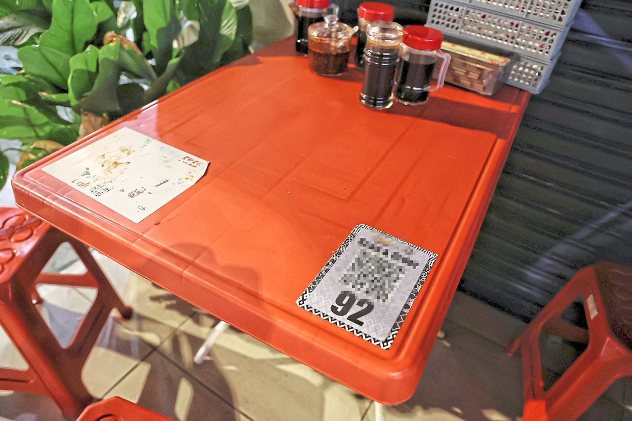 The table does not have a DBKL sticker (inset) to show that the owner has obtained a permit to place it outside the eatery premises.