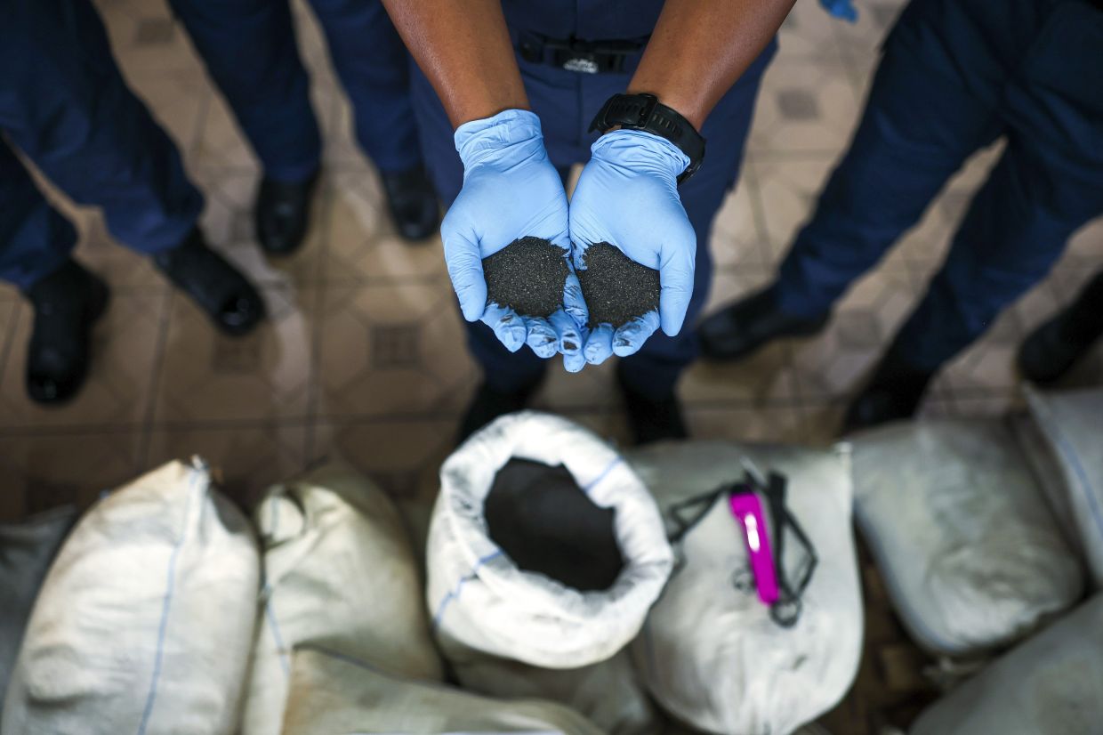 Some of the tin ore seized during the raid. - Photo: Bernama