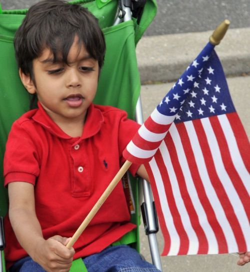 The writer's son, Vicckaash Krishnan, when young with the Star Spangled Banner on US Independence Day.