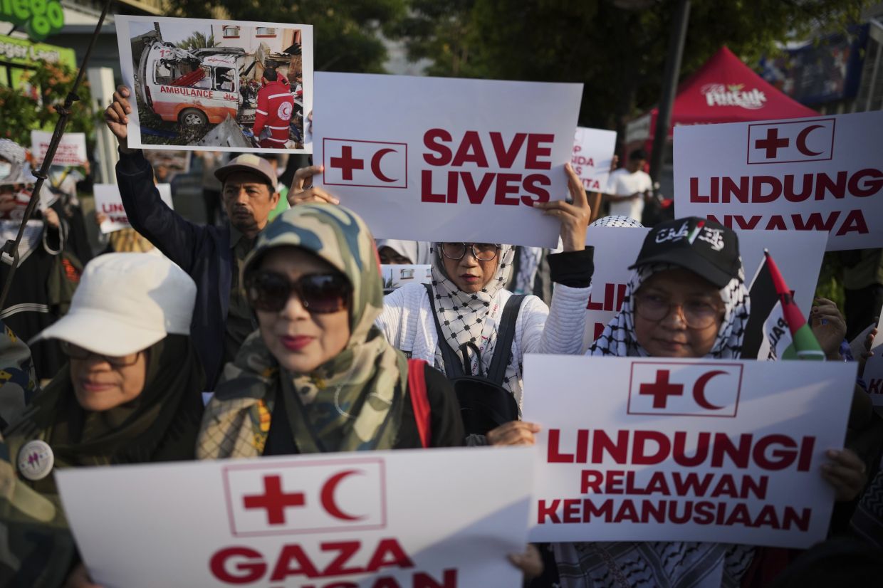 Protesters display posters during a health workers rally against the killing of Palestinian medics by Israeli forces in Gaza, in Jakarta, Indonesia, Monday, April 7, 2025. -- AP Photo/Dita Alangkara