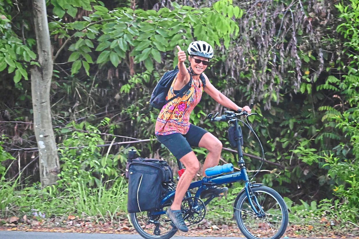 A happy rider working her way uphill towards Pak Khlong from Ban Thale Noi.