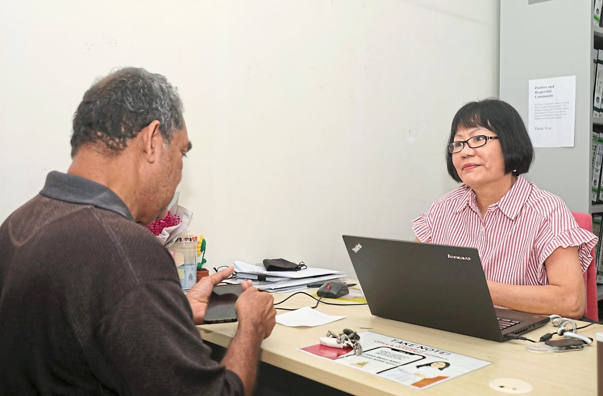 Wong (right) attending to enquiries from a constituent who walked into the Subang Jaya assemblyman’s service centre. 