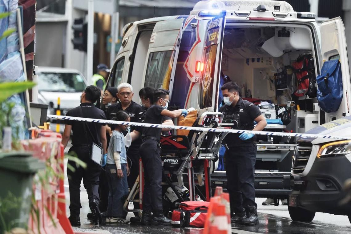 A little girl being escorted to an ambulance at the scene of the fire. -ST