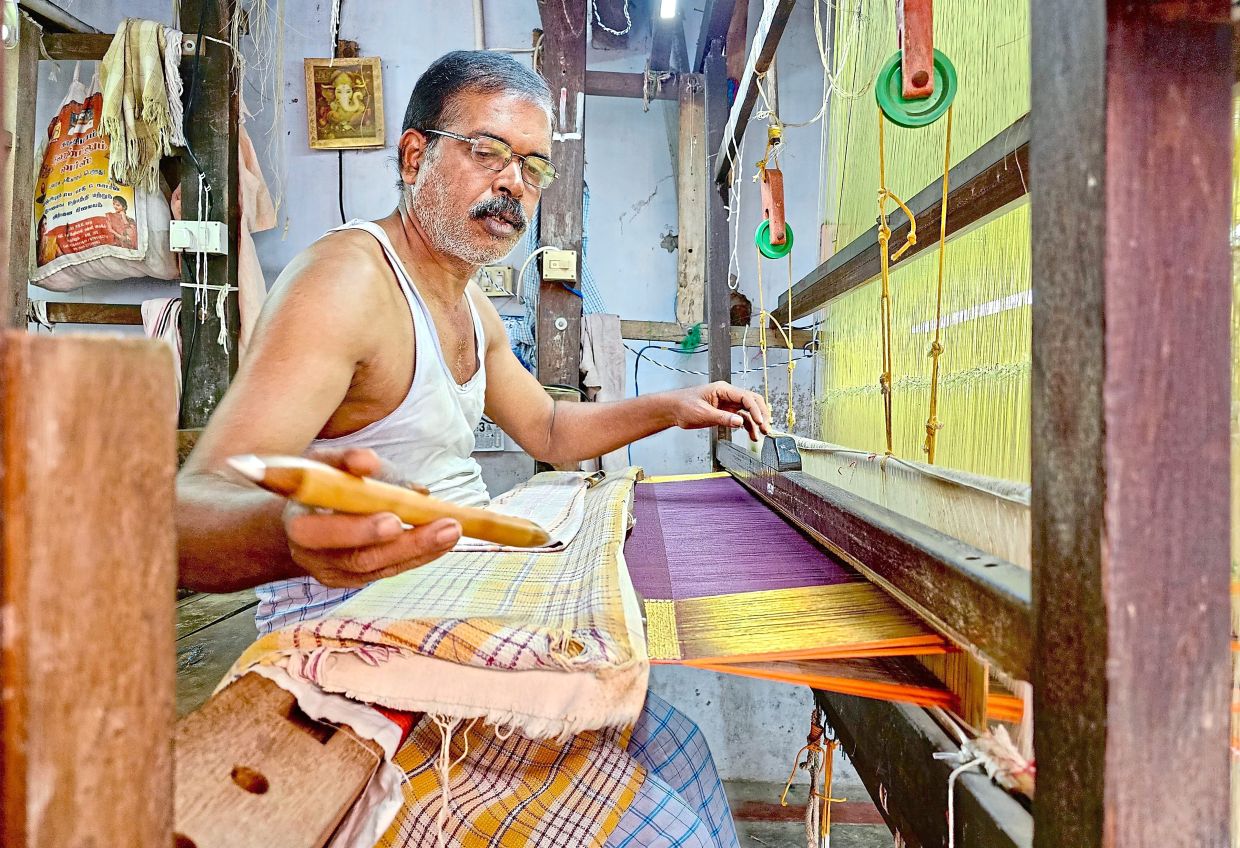 Weaver T. Suresh, 42, working on a silk saree with gold thread in Kanchipuram.