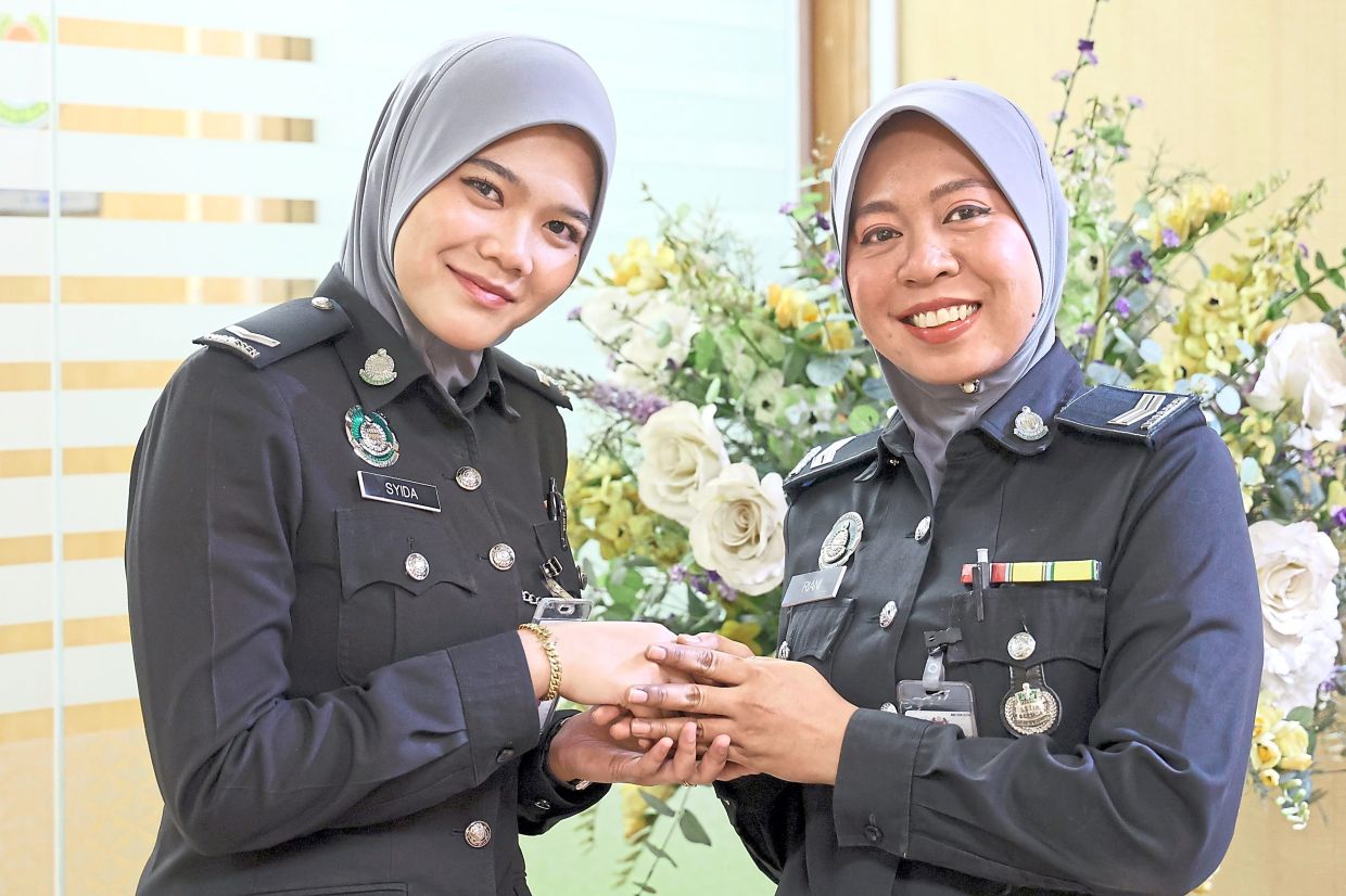 Among Immigration officers working during Hari Raya Aidifitri this year were Nurasyidah (left) and Nurul Zurriani. — Photos: THOMAS YONG/The Star and courtesy pix