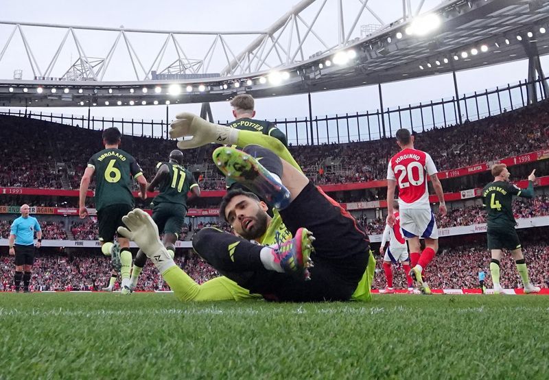 Soccer-Arsenal held at home by Brentford to leave Liverpool closer to title