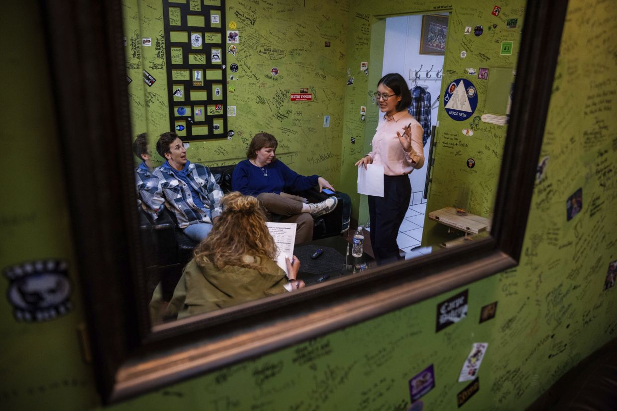 From left, Kaycee Conlee, Ashley Brooke Roberts and emcee Corinna Yee prepare before Stand Up For Climate, a comedy show at Flappers Comedy in Burbank, California. Photo: AP 