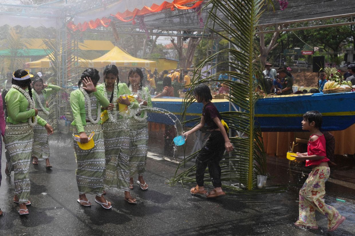 Women are sprayed water during the first day of annual water festival also known as Thingyan, in Naypyitaw, Myanmar, Sunday, April 13, 2025. -- AP Photo/Aung Shine Oo