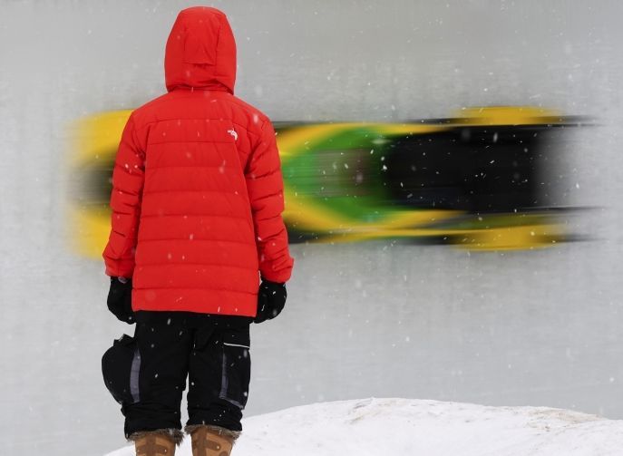 A spectator watching Adanna Johnson of Jamaica race during the third run in the women’s monobob at the bobsledding world championships. — AP