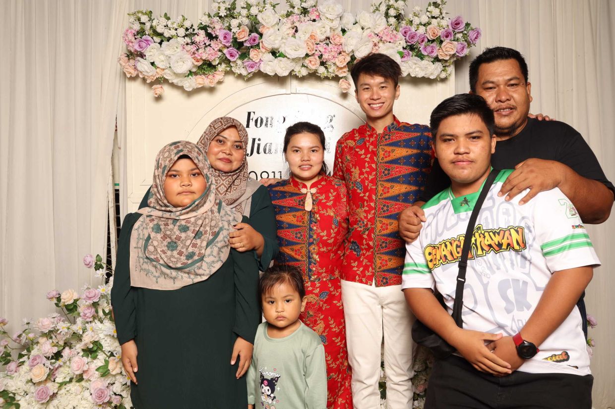 The bridal couple Khaw Fong Fong (third from left) and Cheah Jiang Wei (third from right) with friends who attended the kenduri, locally referred to as makan gulai.