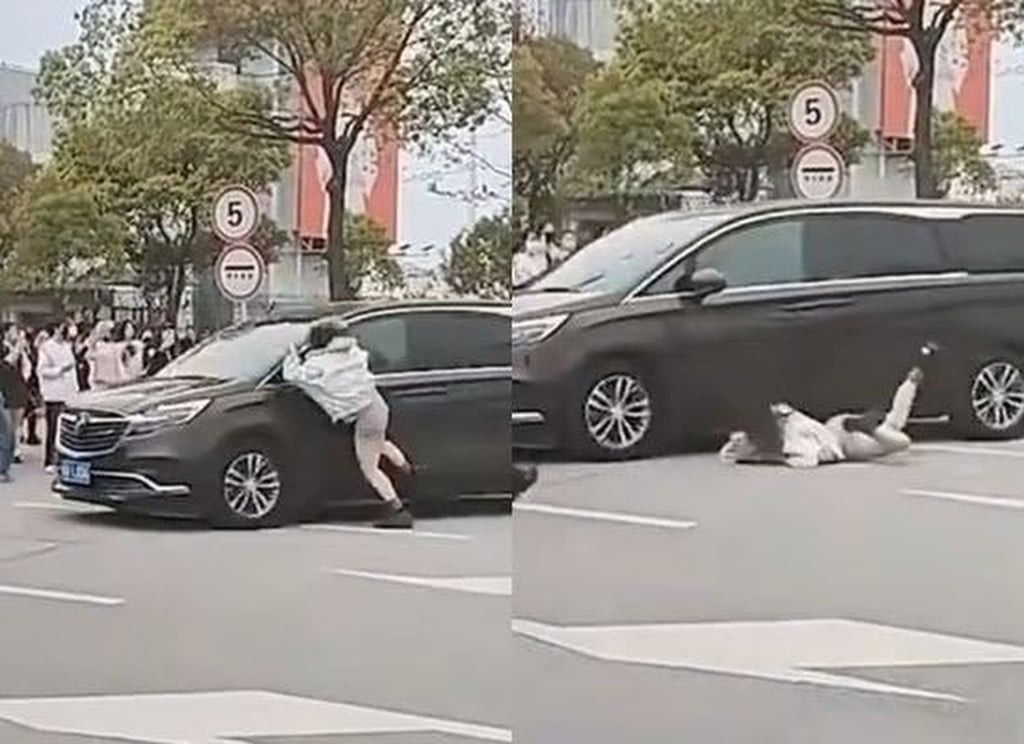 The hyped-up female fan is seen lunging at the band’s car before falling to the ground. - Photo: Handout