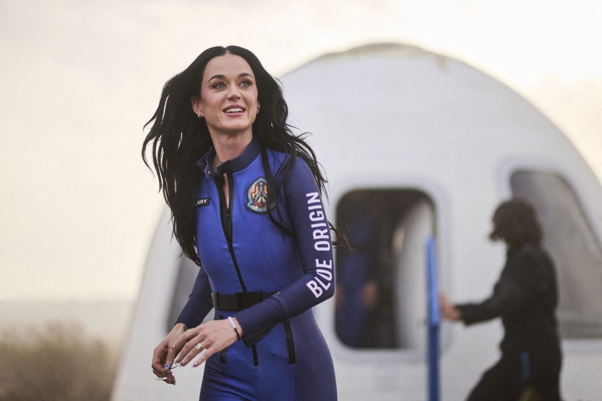 It is reported that Katy Perry was holding a daisy, a flower she took into space, to remind her of her daughter, Daisy. Photo: Handout