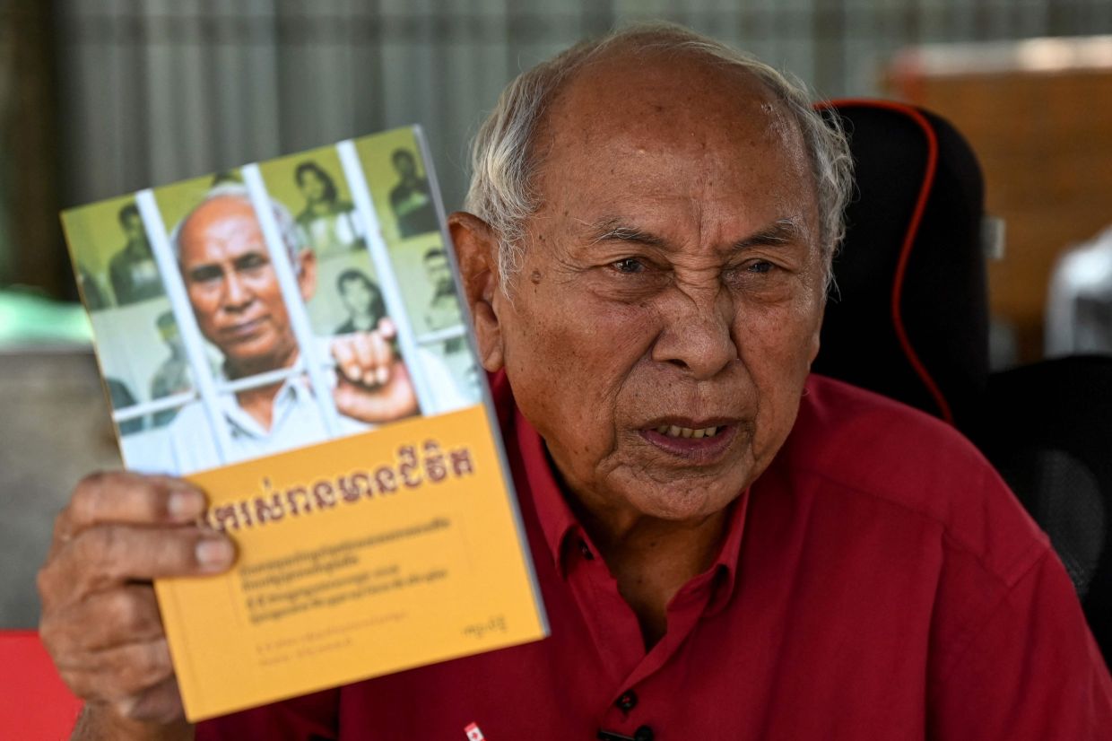 Chum Mey, a survivor of the notorious S-21 prison where an estimated 15,000 people were tortured to death, telling his story during an interview at the Tuol Sleng genocide museum in Phnom Penh. - AFP