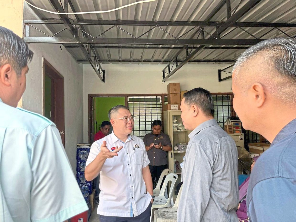 Ling (second from left) learning about the renovation plans at the health clinic.