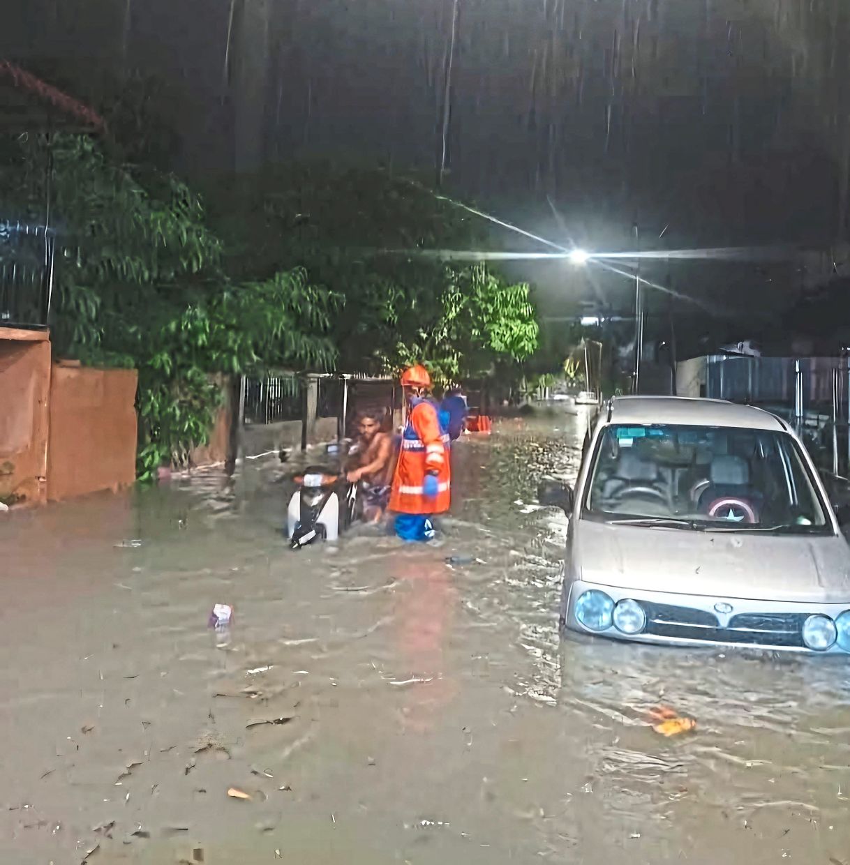Help is here: Penang Civil Defence Force officers assisting residents on Jalan P. Ramlee during floods.