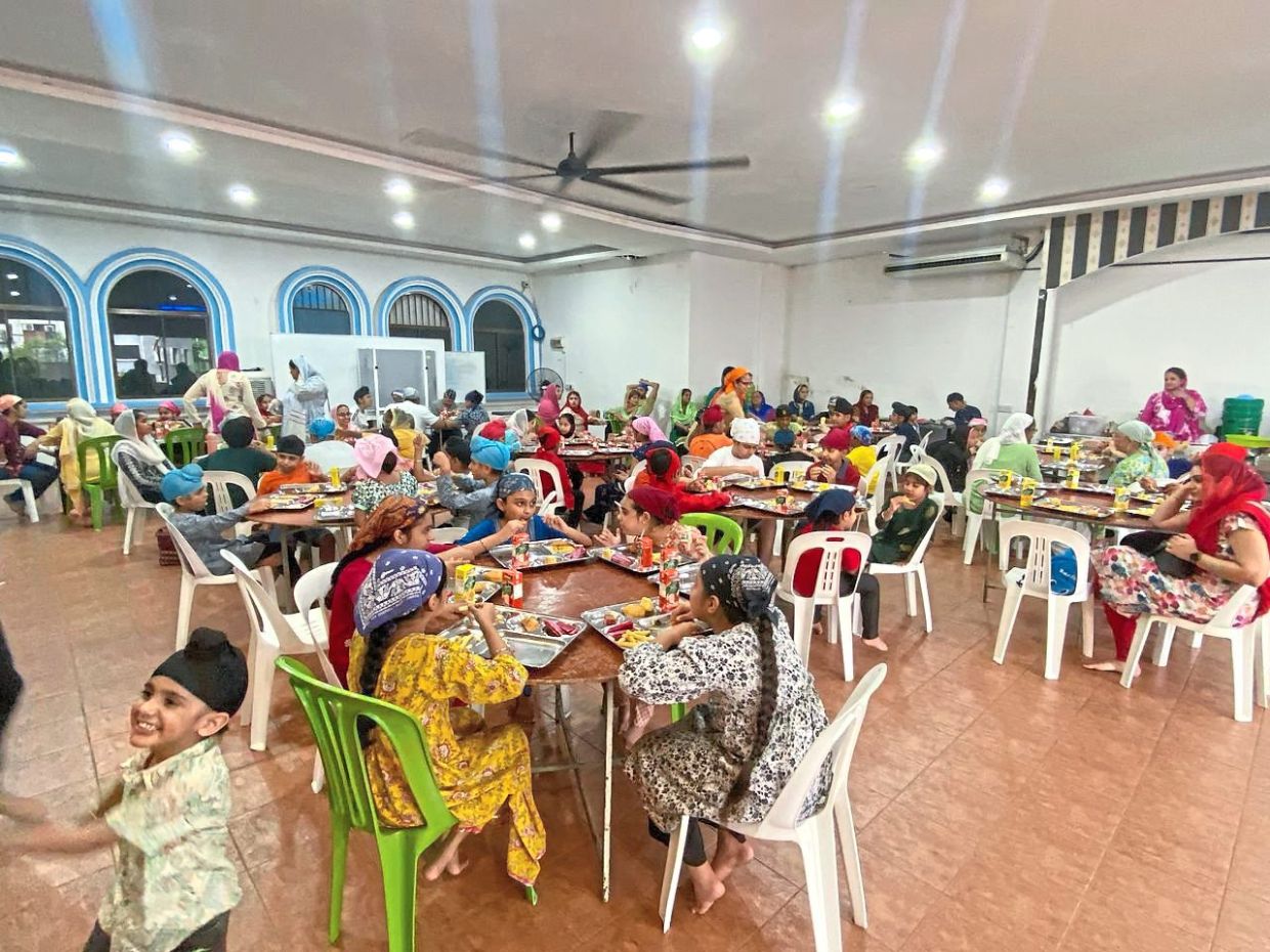 Meal time for children during the Vaisakhi celebration at the gurdwara. — Courtesy photo