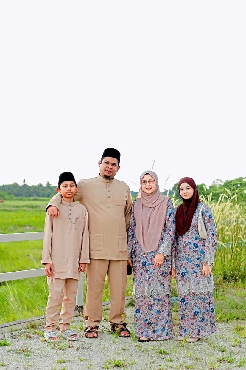 Nor Hafizah (second from right) together with her family. The lecturer began saving in 2020.