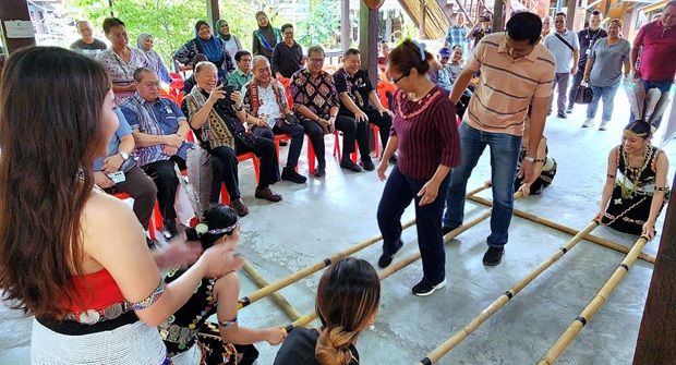 Sabah’s Assistant Tourism, Culture and Environment Minister Datuk Joniston Bangkuai (seated second right), Sarawak’s Deputy Minister of Youth, Sports and Entrepreneur Development Datuk Gerald Rentap Jabu ( third right) and Kadazan Dusun Cultural Association (fourth right) president Tan Sri Joseph Pairin Kitingan (second right) looking at the magunatip dance.