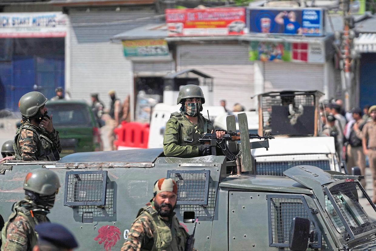 Indian soldiers standing guard in Srinagar. - AP
