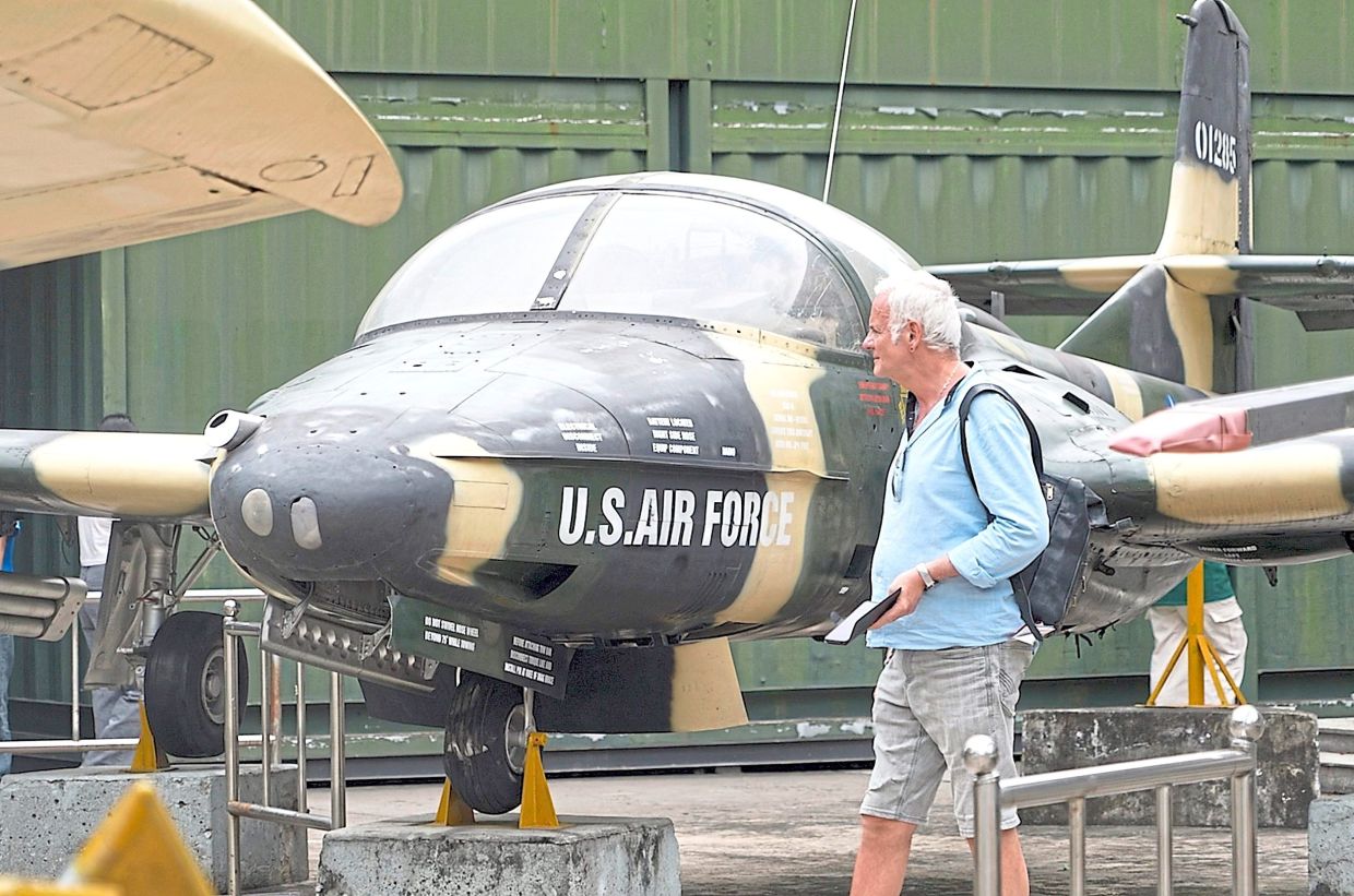 A tourist looking at a US Air Force attack jet used during the Vietnam war at the War Remnants Museum in Ho Chi Minh City.