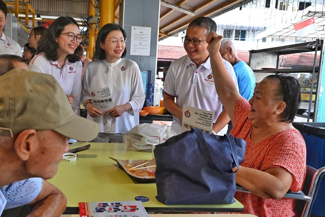 Culture, Community and Youth Minister Edwin Tong (second from right) with (from left) PAP’s East Coast GRC candidate Hazlina Abdul Halim and retired PAP MP Cheryl Chan greeting residents during a walkabout at 85 Fengshan Centre on April 25. - ST
