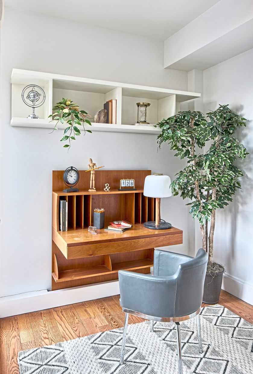A built-in desk helps to conserve space in this home office.