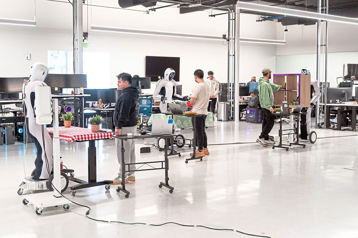 Testing of the Eve model of humanoid robots at the 1X facility in Sunnyvale, California, on Feb. 28, 2025. By getting its humanoid robots into people’s homes, 1X hopes to gather enormous amounts of data that can show these robots how to handle the chaos of daily life.