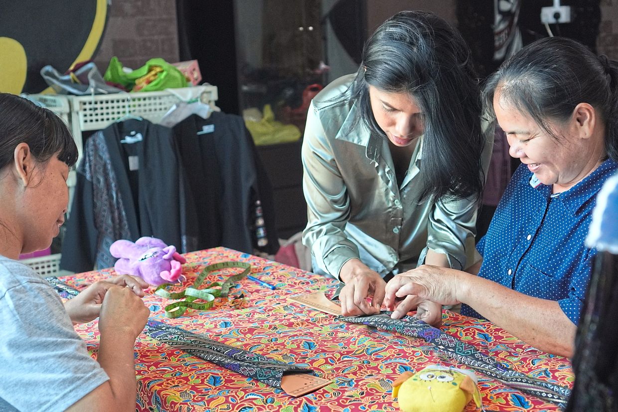 Through G1FT, Zee (centre) is helping women sew their way to a better future in Sabah. 