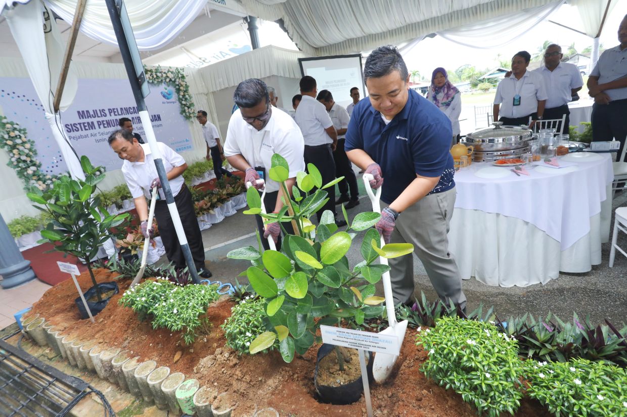 Air Selangor chief executive officer Adam Saffian Ghazali (right) at the launch of a rainwater harvesting system at one of the regional offices, promoting water conservation through sustainable practices.