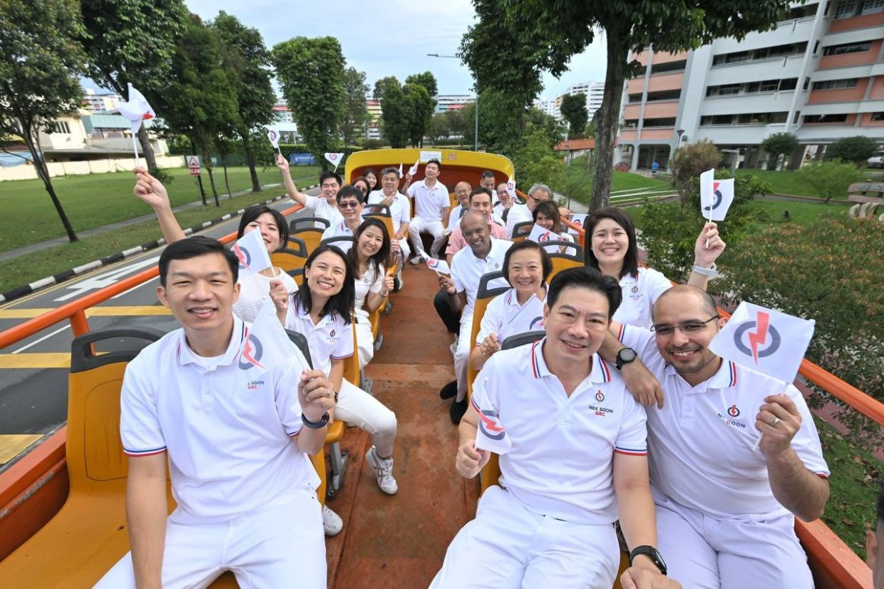 MP-elects for East Coast GRC during their open-top bus tour of the constituency which started at about 8.40am. - ST