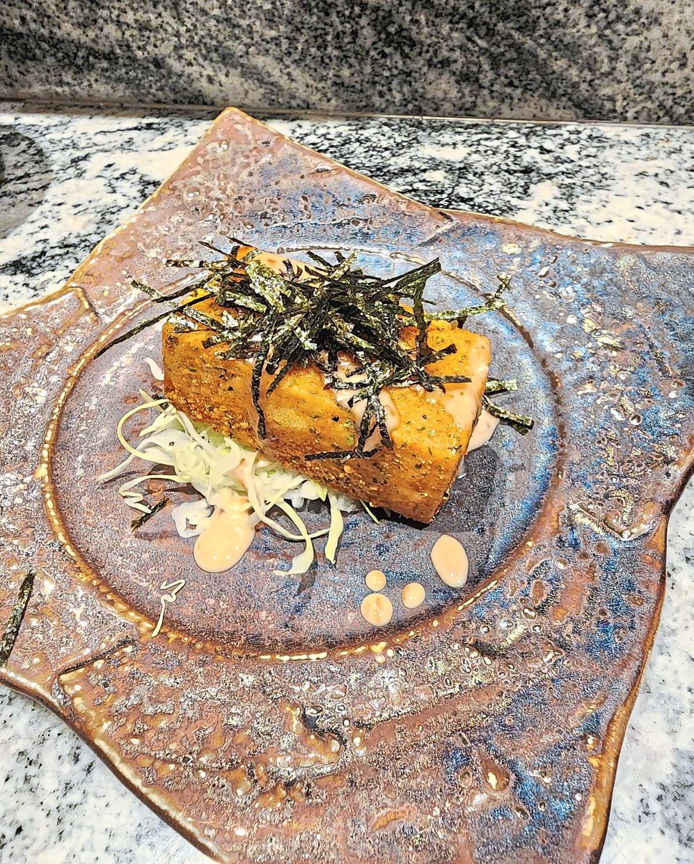 The fried tofu highlights its smooth, silken qualities. 