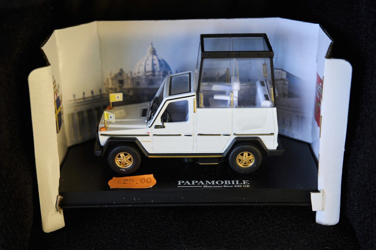 A scale car of the 'popemobile' in Rome is also on sale. 