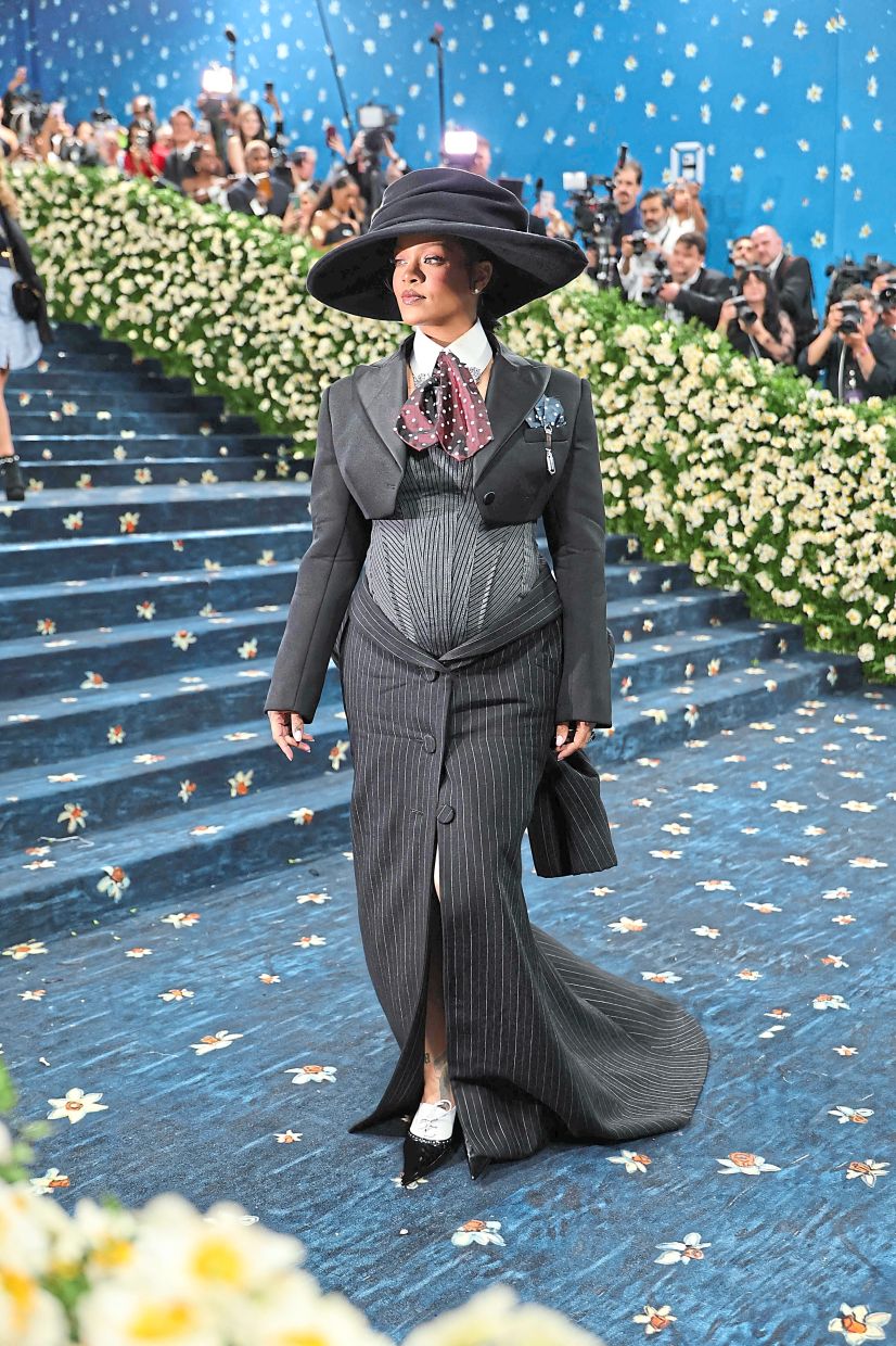 Pop sensation Rihanna shows off her baby bump in a Marc Jacobs skirt suit. Photo: AFP
