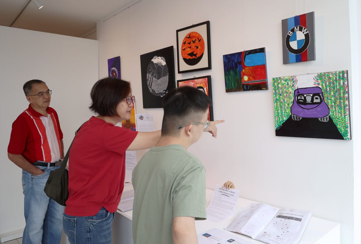 Visitors view Branden and Priya's works at the 'Pintu Bukan Dinding' exhibition, which is open until May 15.