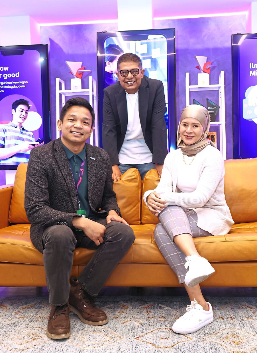 Disrupting the status quo: Kaushik (standing), Fadrizul (seated left) and Hildah are leading GXBank’s charge to revolutionise Malaysia’s financial landscape, leveraging technology for faster and more inclusive financial solutions for all Malaysians. — ART CHEN/The Star