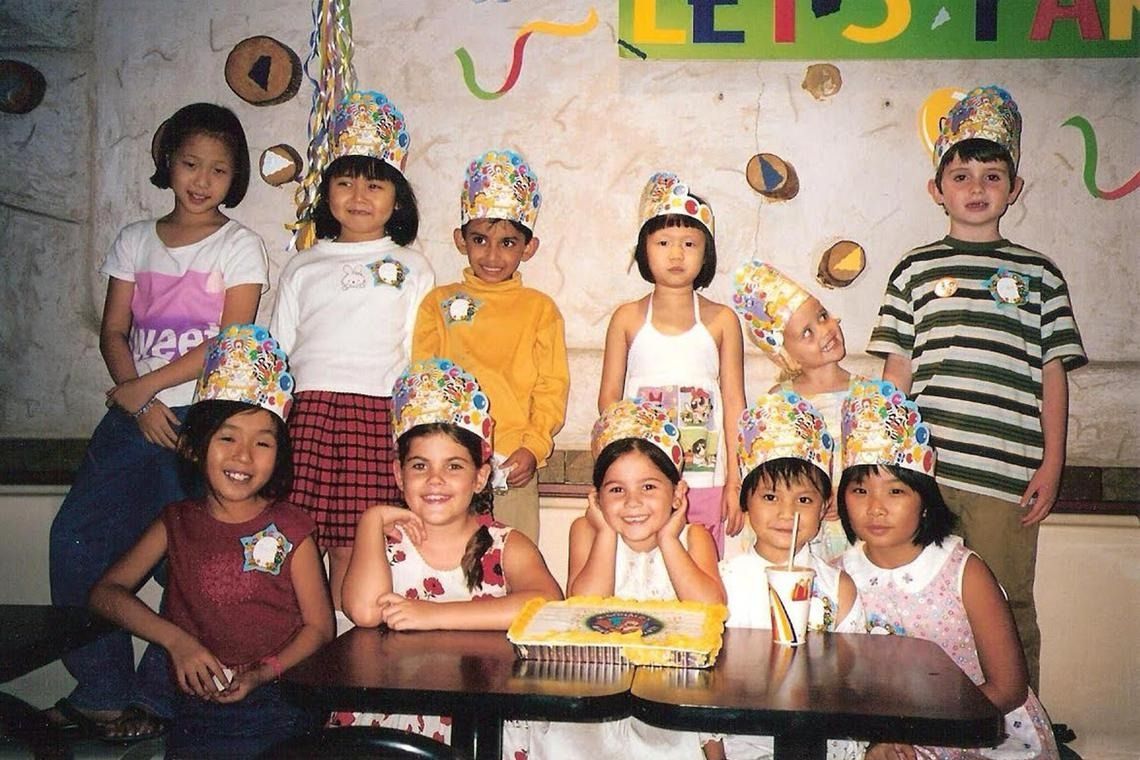 Roberts (front row, in front of cake) celebrating her seventh birthday at a McDonald’s restaurant in Hougang with her schoolmates from Parry Primary School, and some family friends. Parry Primary School merged with Xinghua Primary School in 2007. - COURTESY OF GRACE ROBERTS