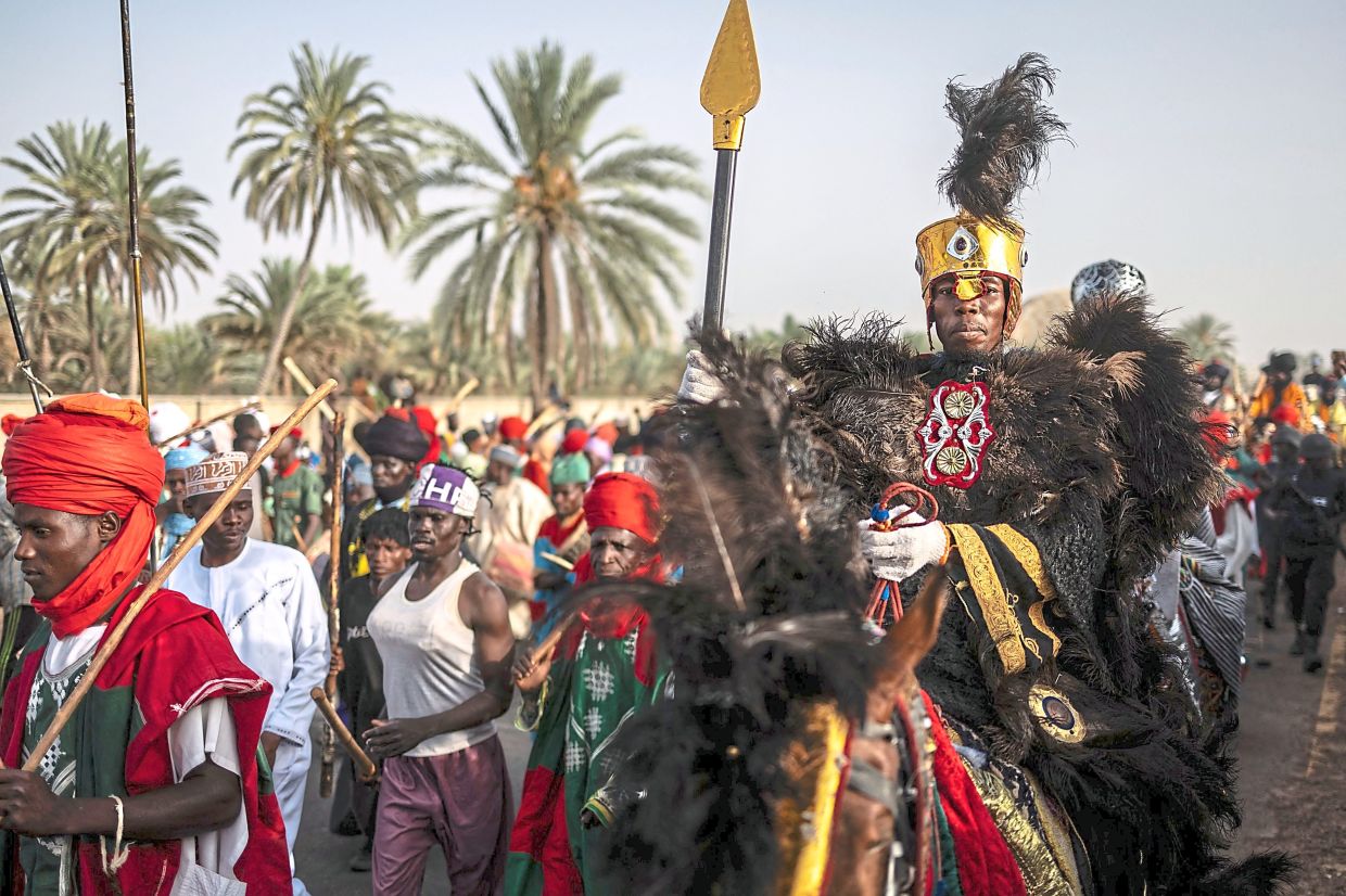 A horseman parading as he rides during the Durbar horse procession in Dutse. Durbar is a colourful procession of horses dating back to the 15th century in which the emir and thousands of horse riders accompanied musicians march through the streets in predominantly Muslim northern Nigeria. Although the festival originated in North’s largest city of Kano. — AFP