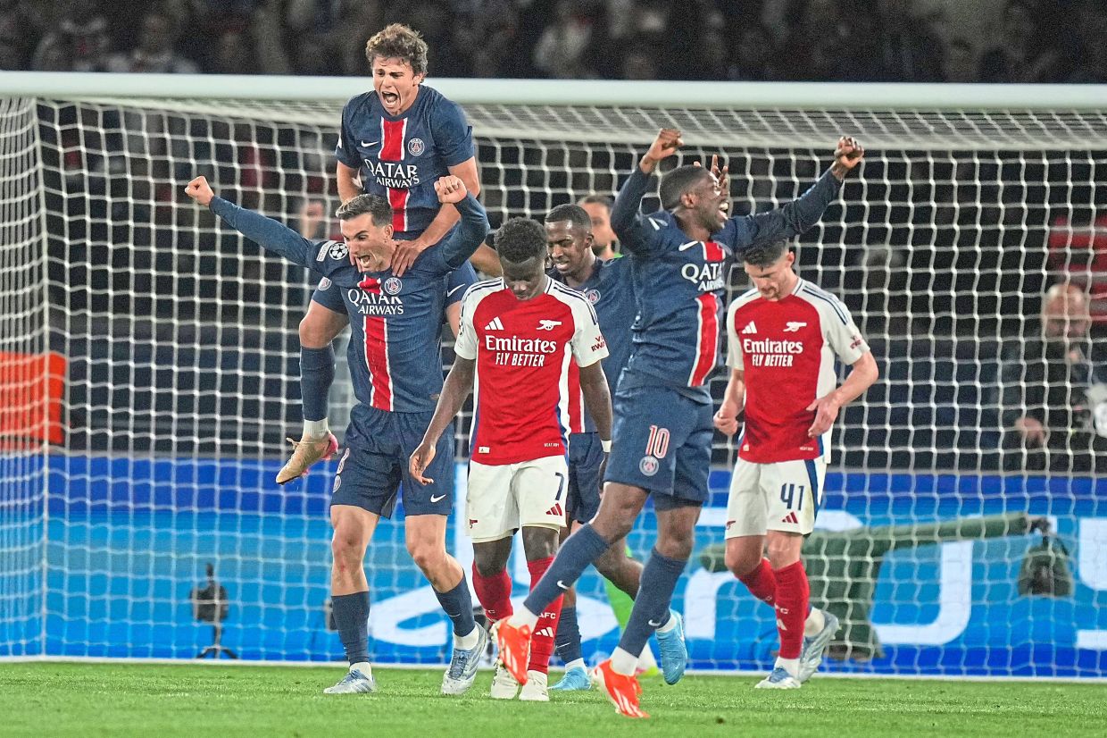 PSG players celebrate after scoring another goal against Arsenal at the Parc des Princes. — AP