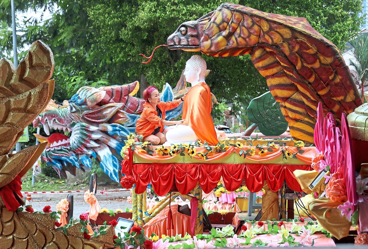 Ready to go: Volunteer GC Yong making final touches to one of the floats for the Wesak Day procession at the Chempaka Buddhist Lodge, Petaling Jaya. — ART CHEN/The Star
