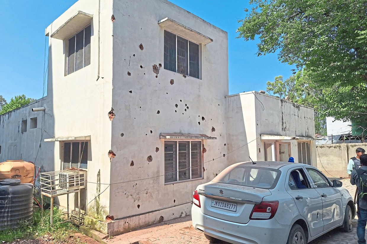 A residence of a senior government official damaged by a Pakistan shelling is seen in Rajouri. -AP