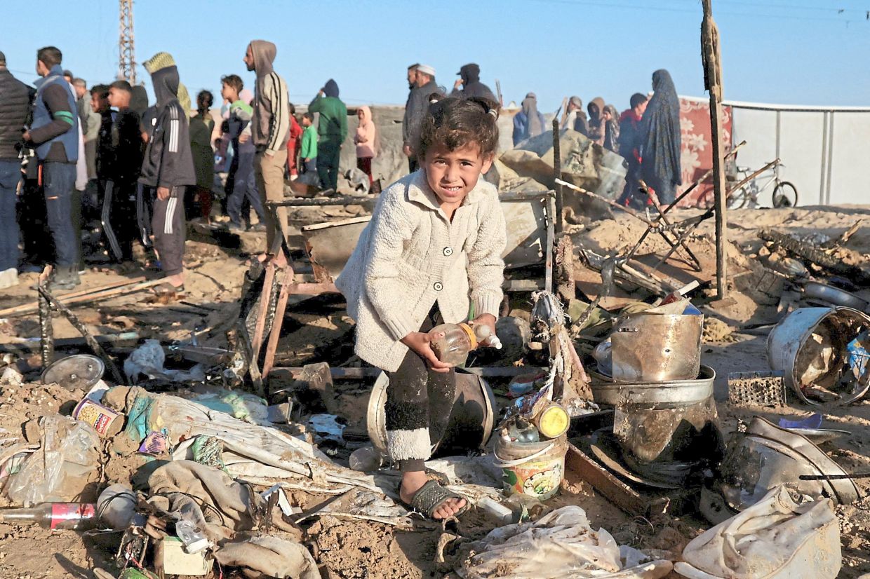 A child looking on at the site of an Israeli strike on a tent camp in Khan Yunis. — Reuters