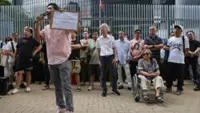 Hong Kong authorities warn ride-hailing firms about legality as taxi drivers petition