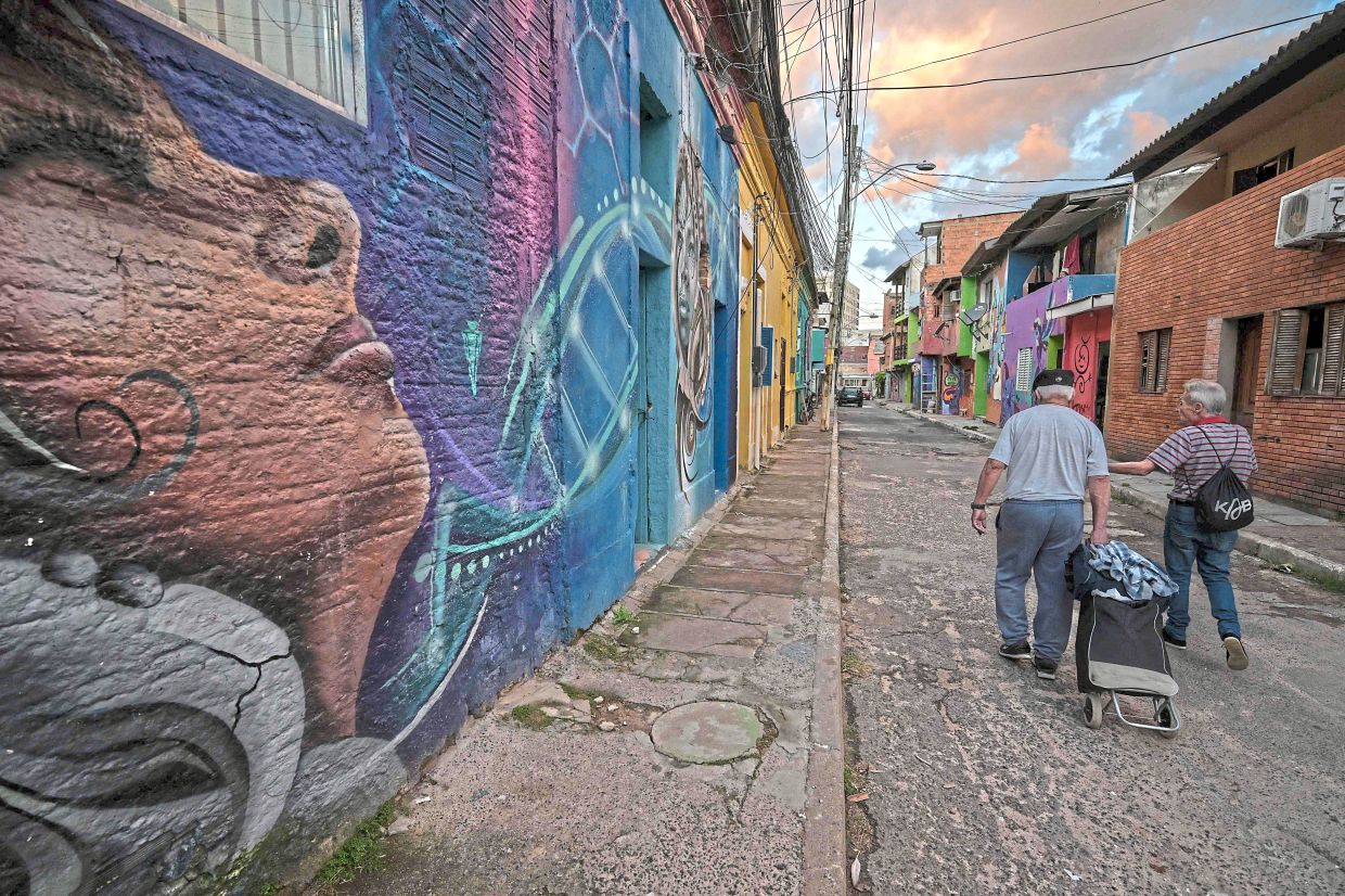 View of houses painted by artists from the Paredes com Proposito (Purposeful Walls) project at the Menino Deus neighbourhood in Porto Alegre, Rio Grande do Sul state, Brazil. — AFP
