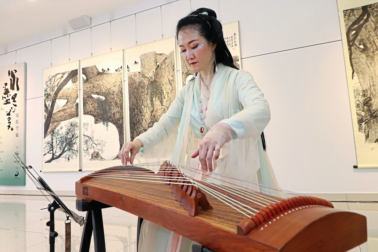 A ‘guzheng’ performance at the exhibition launch at the Soka Gakkai Malaysia branch in Bayan Lepas.