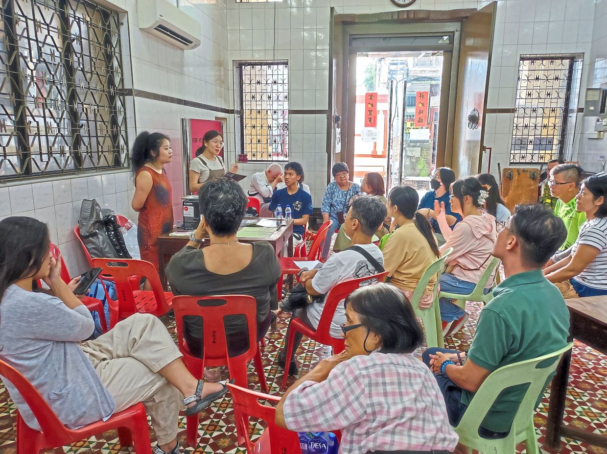 A workshop entitled 'What Happens After Leaving', led by Chen (standing, left), held during the exhibition which encouraged participants to explore how the majie adapted after arriving in Penang. Photo: Andrea Filmer