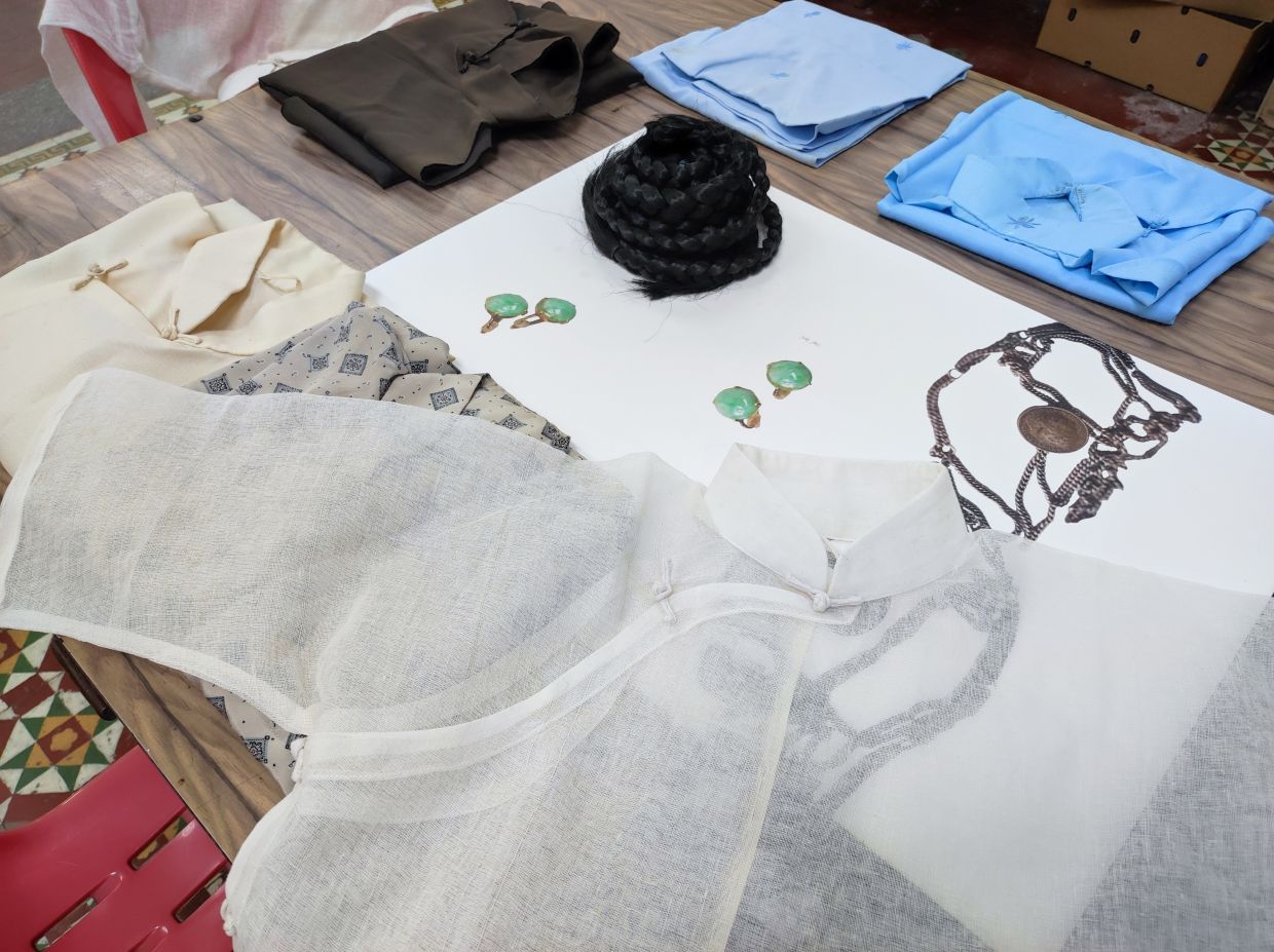 Clothing and accessories worn by majie back in the day, along with a cotton, transparent replica for visitors to touch and handle. Photo: Andrea Filmer