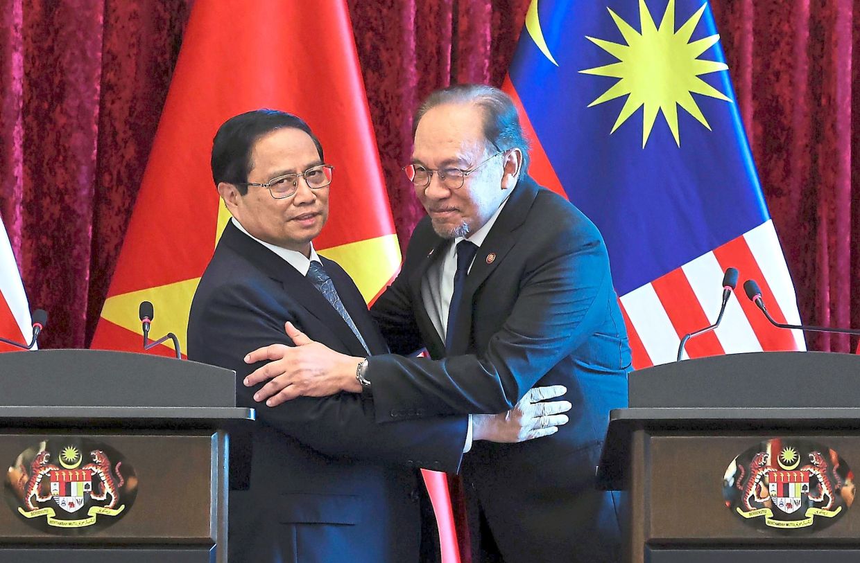 Anwar greeting Chinh at a joint press conference at Perdana Putra.— Bernama