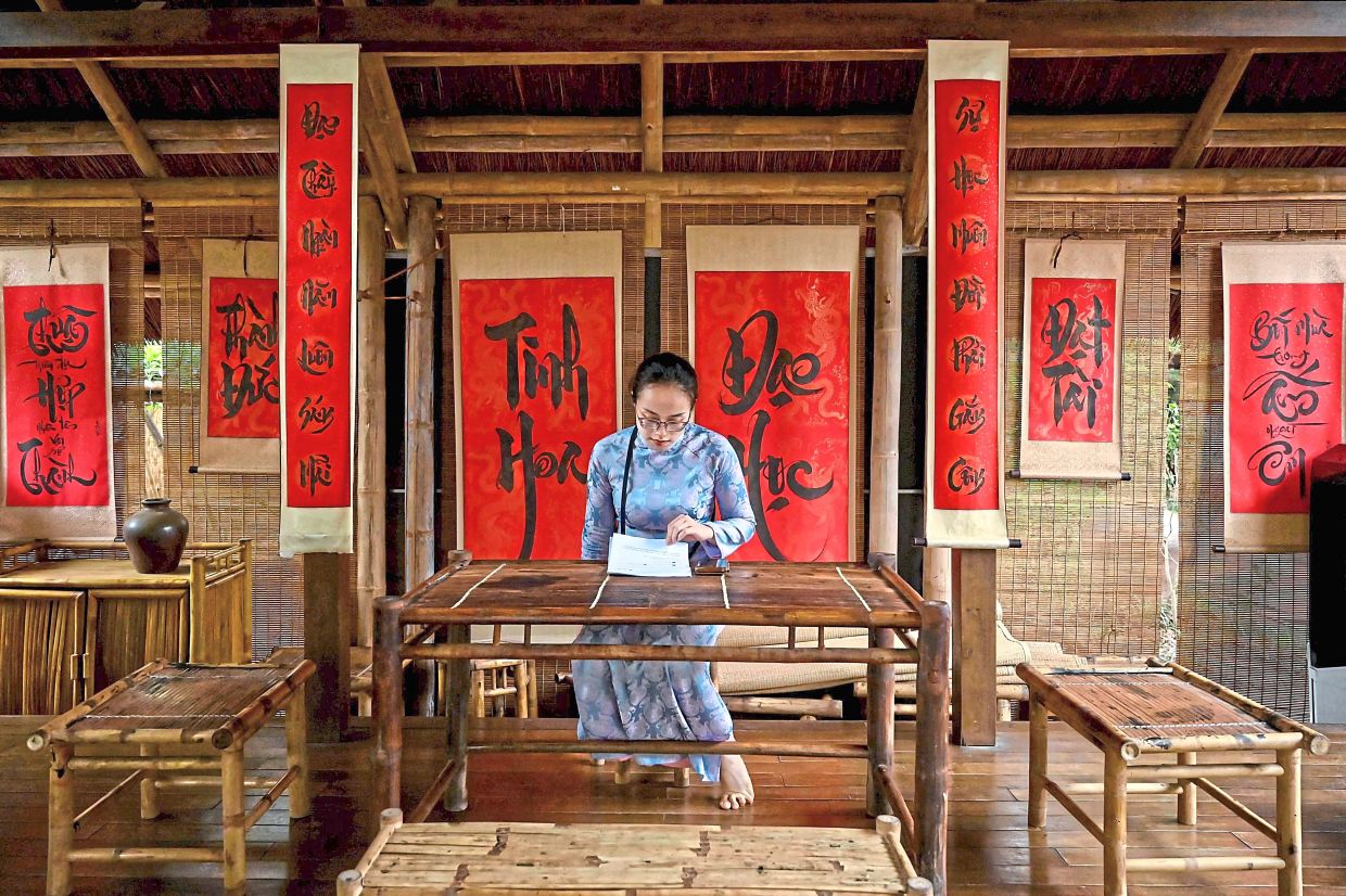 Ink-redible: A woman reading inside the calligraphy house at the Temple of Literature. — AFP