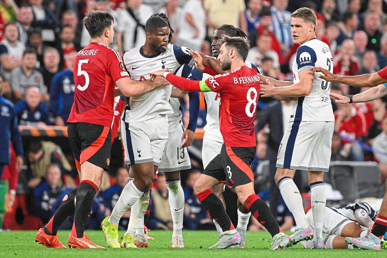 United’s Harry Maguire and Bruno Fernandes in a scuffle with Tottenham’s Kevin Danso. — AFP
